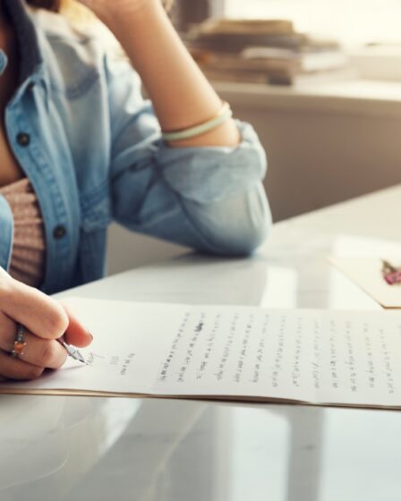 Caucasian woman writing a letter
