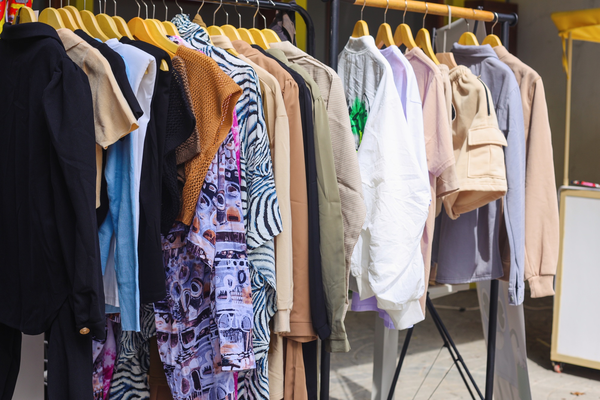 Clothes on a rack in a flea market.