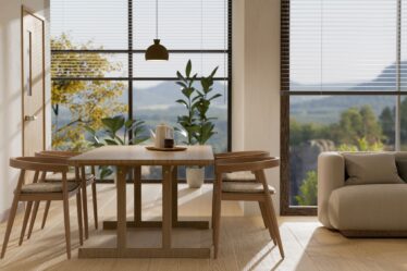 Minimal wood dining table set with sofa, home decor and amazing glass window in background.